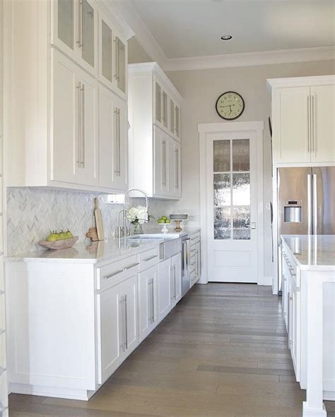 galley kitchen white cabinet stainless steel appliances light marble countertop|white galley kitchen designs.